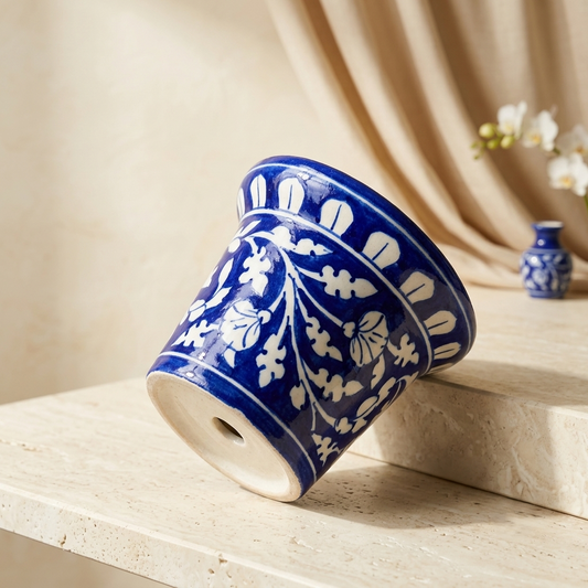 Cobalt Blue Pottery ceramic planter with hand-painted white floral vine, flared rim and tapered base form