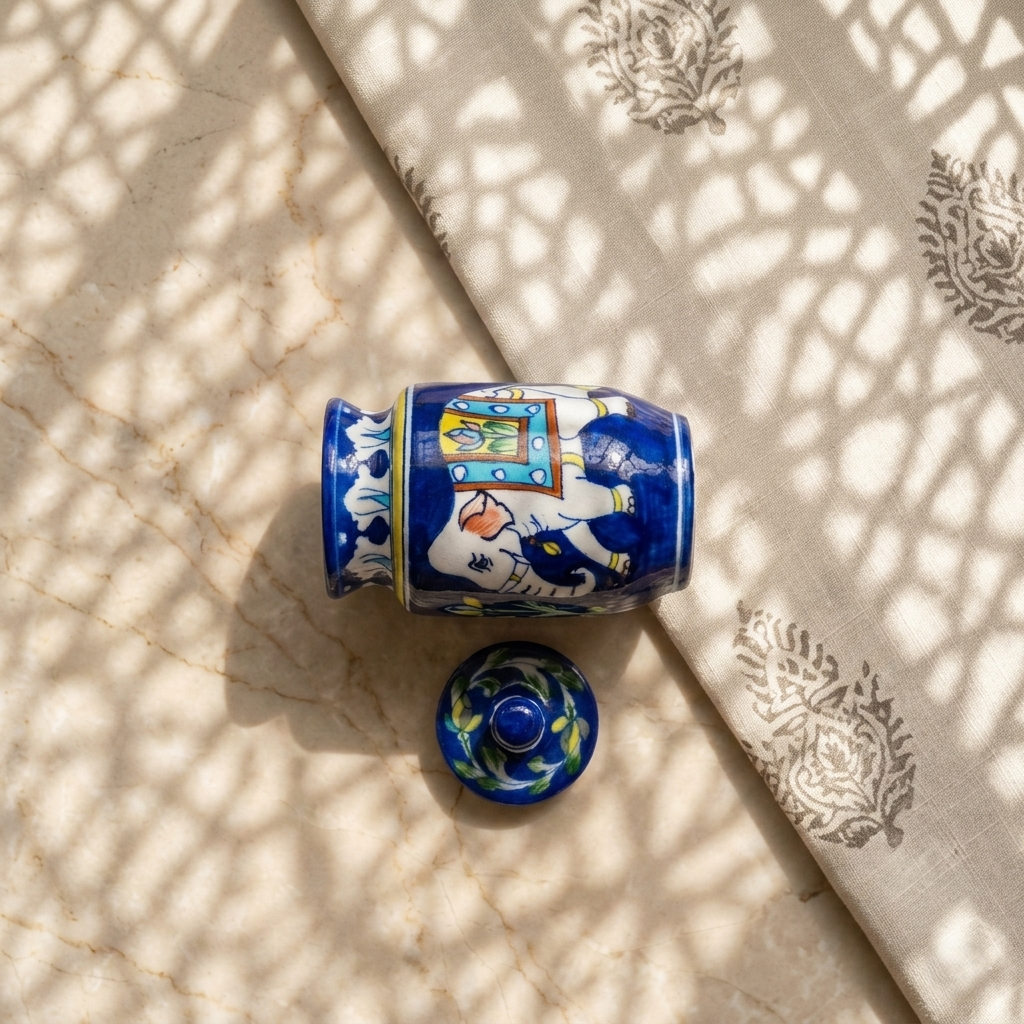 Hand-painted Blue Pottery jar with elephant and decorative howdah motif, lidded ceramic container