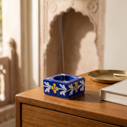 Handcrafted Jaipur Blue Pottery candle holder with traditional floral design displayed on a wooden shelf for luxury home décor.