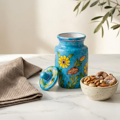 Blue Pottery ceramic jar used as a dry storage container, lid off, nuts displayed in a bowl alongside