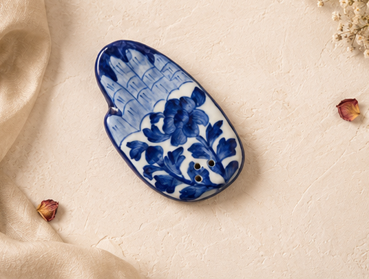 Jaipur Blue Pottery hand incense stand — flat palm form, white botanical motif on cobalt, unlit product