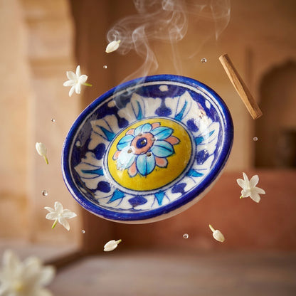 Hand-painted ceramic agarbatti holder with rising incense smoke and floating petals, spiritual home décor