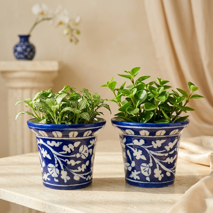 Pair of Jaipur Blue Pottery planters with green pothos plants, hand-painted white botanical vine design