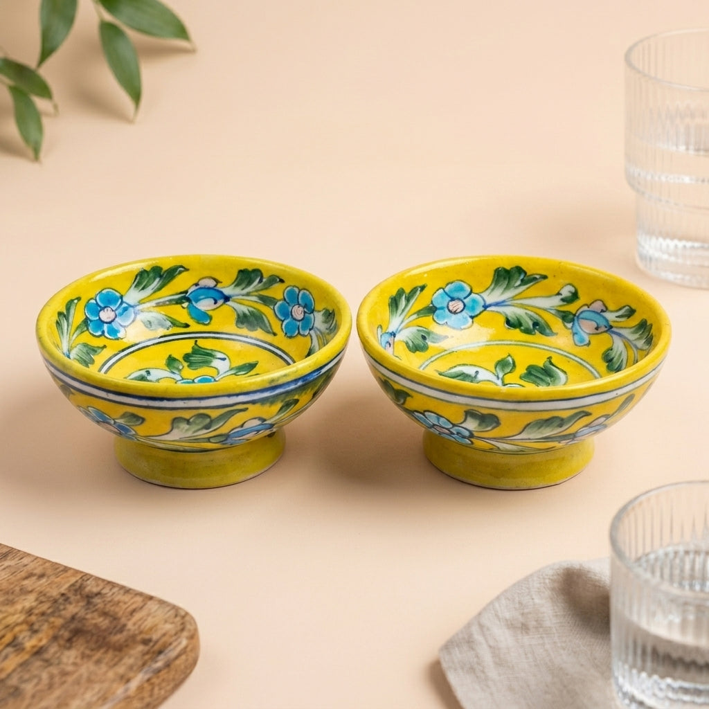 Set of 2 handpainted yellow Jaipur Blue Pottery bowls featuring cobalt blue floral motifs on a warm beige background