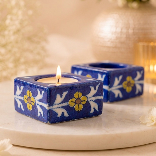 Jaipur Blue Pottery handpainted candle holder with a lit tealight featuring hand-painted floral artwork for festive home décor