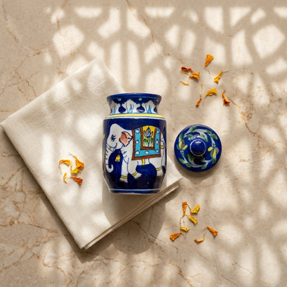 Traditional Jaipur Blue Pottery storage jar with elephant motif, displayed in a carved heritage interior